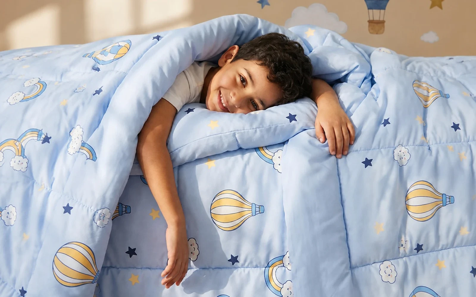 Child resting comfortably on soft kids bedding with hot-air balloon prints
